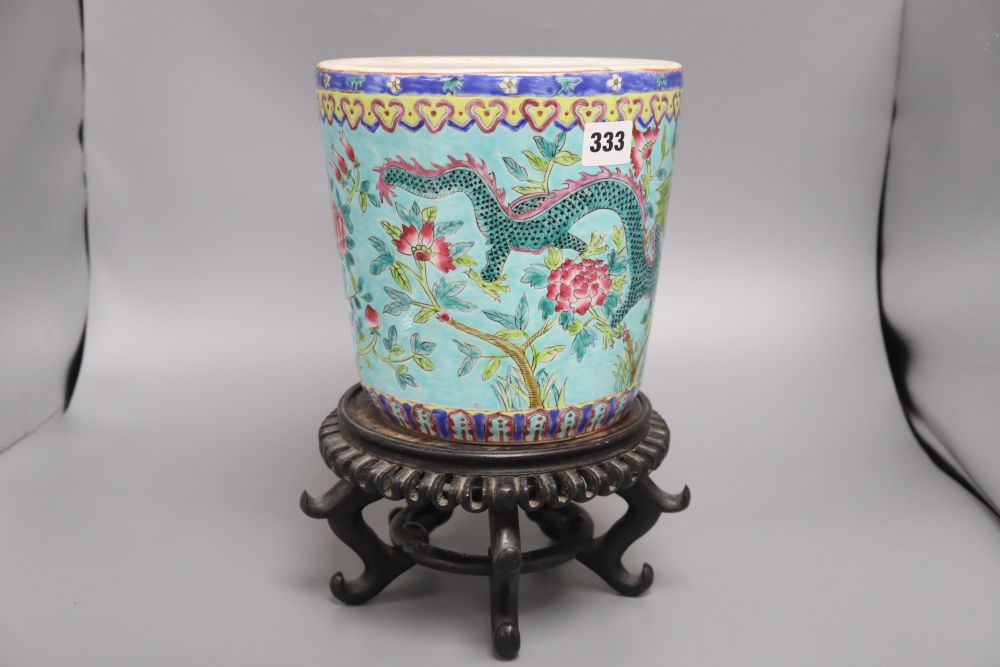 A Chinese turquoise glazed dragon jardiniere and wood stand, overall 33cm